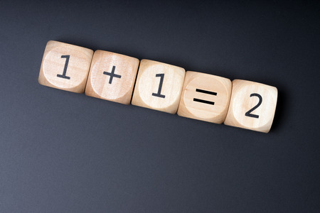 Wooden cube with one plus one equals twoの写真素材