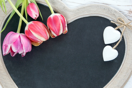 Wooden panel in heart shape with tulips
