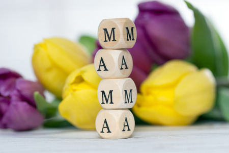 Wooden cube with tulips and the word Mamaの写真素材