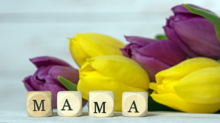 Wooden cube with tulips and the word Mamaの写真素材
