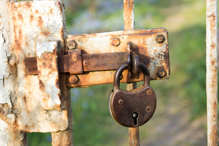Old padlock on a fenceの写真素材