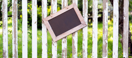 empty plate on a garden fenceの写真素材