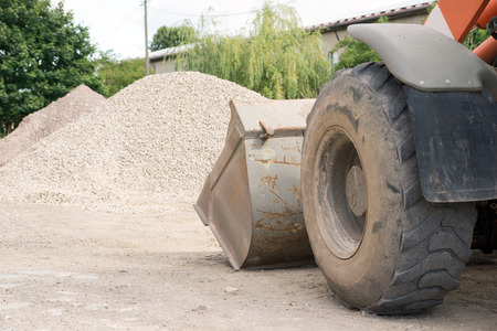 large wheel loader and a pile of stones