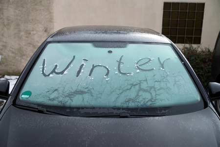 frozen windshield of a car with the word winterの写真素材