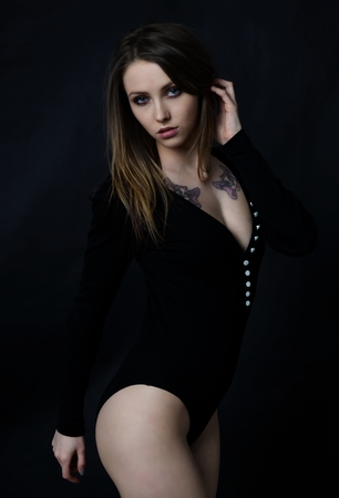 Woman in a Bodysuit in front of a dark backgroundの写真素材