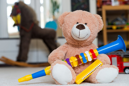Teddy bear with a clarinet and harmonicaの写真素材
