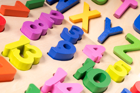 Colorful numbers and letters on a wooden boardの写真素材