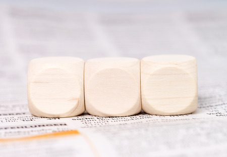 empty wooden cubes on a newspaperの写真素材