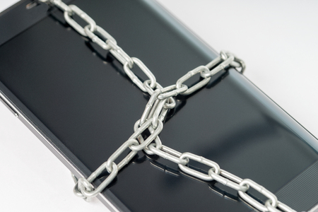 Black smartphone with a metal chainの写真素材