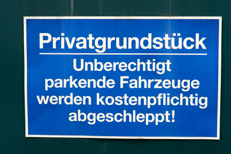 sign at a gate with the german words private property