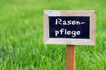 sign with the words Lawn care stands on the green lawnの写真素材