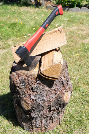Firewood and an ax in a gardenの写真素材