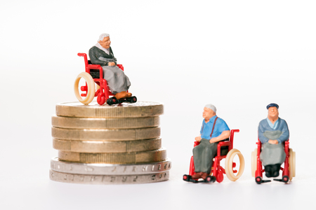 old people in wheelchairs and coinsの写真素材