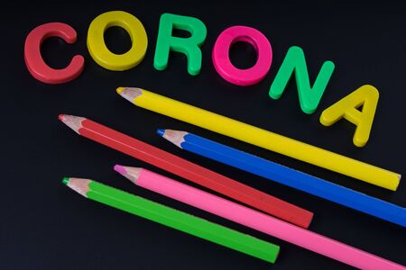 Blackboard with the word corona and colored pencilsの写真素材