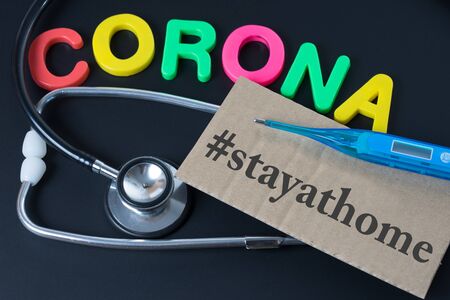 Blackboard with the word Corona and stay at homeの写真素材