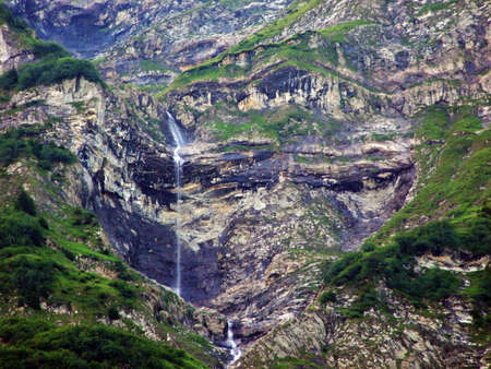 Seasonal waterfalls on the tributaries of the Jetzbach stream and in the alpine valley of Im Loch - Canton of Glarus, Switzerlandの写真素材