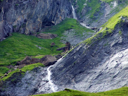 Nameless waterfalls under the Alpine peaks Glarner Vorab and BÃ¼nder Vorab in the valley of Im Loch - Canton of Glarus, Switzerlandの写真素材