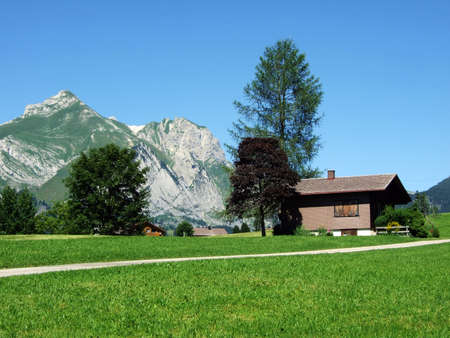 Rural traditional architecture and livestock farms on the slopes of the Alviergruppe mountain range...