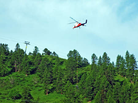 Servicing with repair of the ski lift and delivery of new parts by helicopter on the slopes of the...