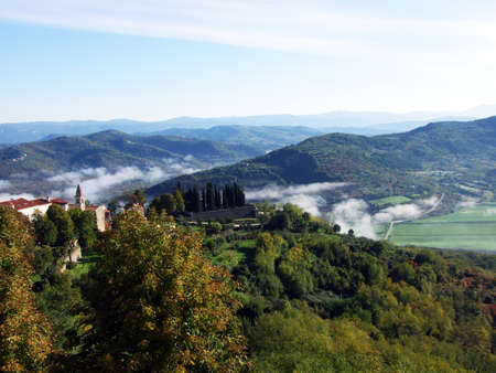 View of the Mirna River valley and autumn morning fog from the old town of Motovun - Istra, Croatia (Pogled na dolinu rijeke Mirne i jesenju jutarnju maglu sa starog grada Motovuna - Istra, Hrvatska)の写真素材