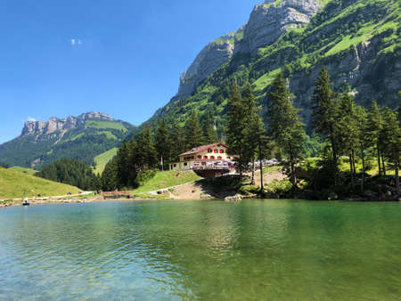 Mountain restaurants on the shore of the Seealpsee alpine lake in the Appenzellerland region -...