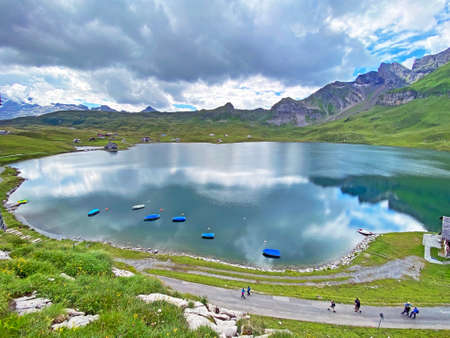 Boats on the artificial alpine lake Melchsee or Melch lake in the Uri Alps mountain massif, Melchtal - Canton of Obwalden, Switzerland (Kanton Obwald, Schweiz)の写真素材