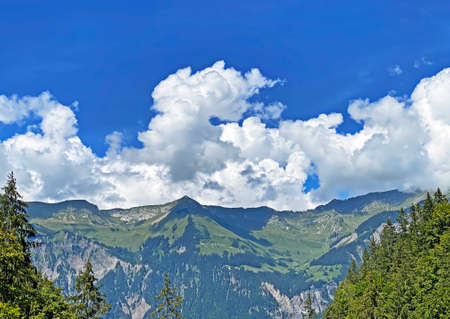 Beautiful photogenic clouds over Lake Brienz (Brienzersee) and the surrounding alpine peaks - Canton of Bern, Switzerland (Kanton Bern, Schweiz)の写真素材