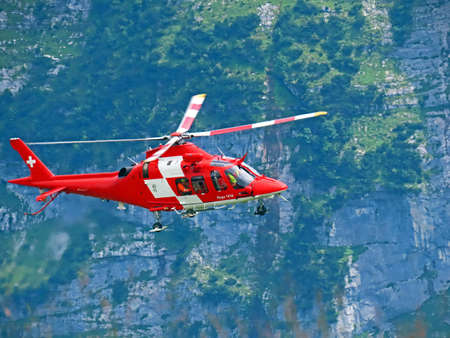 Rega - Swiss Air-Rescue or Swiss Air-Ambulance Helicopter - Die Rega Rettungshelikopter (Rettungsflugwacht und Garde AeriÃ¨nne), Innertkirchen - Canton of Bern, Switzerland (Kanton Bern, Schweiz)のeditorial素材