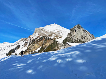 Winter atmosphere on the alpine peak Wildhuser Schofberg in Alpstein mountain range and in Appenzell...