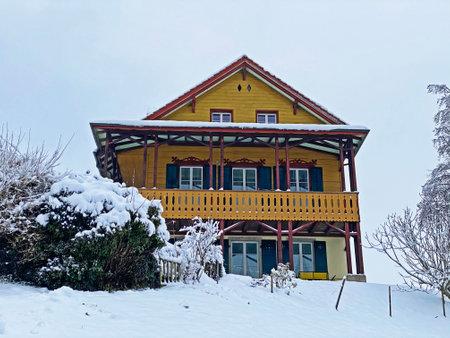 Idyllic Swiss alpine mountain huts and traditional Swiss rural architecture dressed in winter clothes and in a fresh snow cover on the slopes of Mountain Rigi, Weggis - Canton of Lucerne, Switzerlandの写真素材