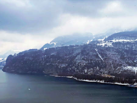 Snow-capped alpine peaks and winter in mixed forests above Lake Walen or Lake Walenstadt (Walensee), Weesen - Canton of St. Gallen, Switzerland (Kanton St. Gallen, Schweiz)の写真素材