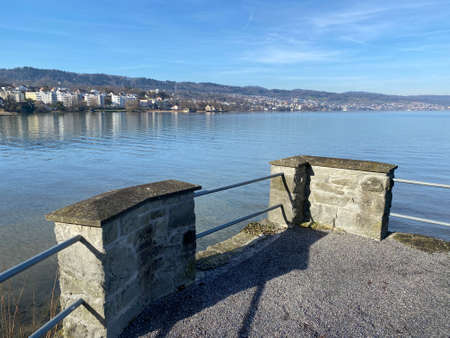 Lake Zurich (Zuerichsee oder ZÃ¼richsee) and a coastal landscape with vegetation in late winter in...