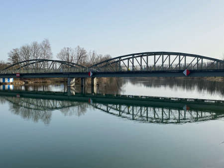 An iron bridge over the river Reuss (ReussbrÃ¼cke) and in the natural protection zone Aargau Reuss river plain (Naturschutzzone Aargauische Auen in der Reussebene), Rottenschwil - Switzerland (Schweiz)の写真素材