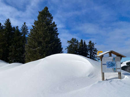 Hiking markings and orientation signs with signposts for navigating in the idyllic winter ambience...