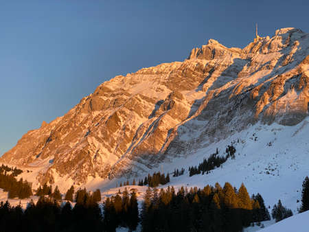 Winter ambience and beautiful idyllic atmosphere on the snow-capped Alpine mountain Alpstein in the...