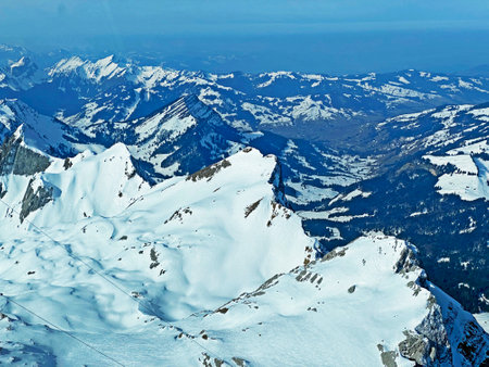 View of the snowy alpine peaks from SÃ¤ntis, the highest peak of the Alpstein mountain range in the Swiss Alps - Canton of Appenzell Innerrhoden, Switzerland (Schweiz)の写真素材