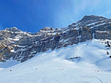 Idyllic steep alpine rocky peaks of the Swiss Alpstein massif dressed in icy pure white snow cover - Canton of Appenzell Ausserrhoden, Switzerland (Schweiz)の写真素材