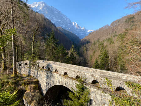 Old stone bridge over the river LÃ¶ntsch and over the canyon LÃ¶ntschtobel at the foot of the alpine reservoir KlÃ¶ntalersee (or Kloentalersee) - Canton of Glarus, Switzerland (Schweiz)の写真素材