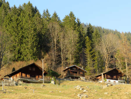 Mountain huts (chalets) or farmhouses and old wooden cattle houses in the alpine valley of KlÃ¶ntal (or Kloental) and by the resevoir lake KlÃ¶ntalersee (Kloentalersee) - Canton of Glarus, Switzerlandのeditorial素材