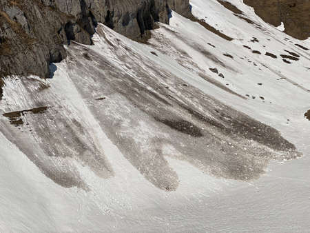 Melting snow cover and early spring ambience in the alpine valleys and icy peaks of the Glarus Alps mountain massif - Canton of Glarus, Switzerland (Schweiz)の写真素材