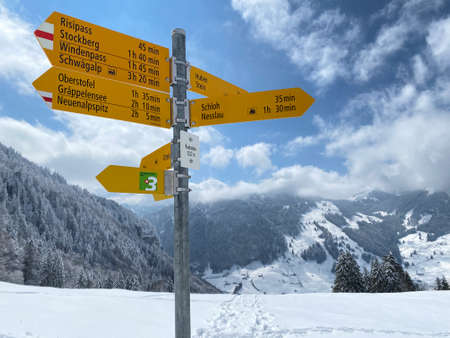 Hiking markings and orientation signs with signposts for navigating in the idyllic winter ambience...