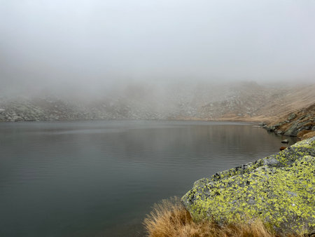 Mystical autumn ambience on the alpine lake Lago d'Orsino in the mountainous area of the St. Gotthard Pass (Gotthardpass), Airolo - Canton of Ticino (Tessin), Switzerland (Schweiz)の写真素材