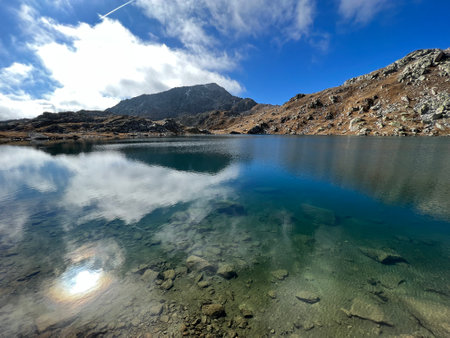 A crystal clear alpine lakes Laghi d'Orsirora during a beautiful autumn day in the mountainous area of the St. Gotthard Pass (Gotthardpass), Airolo - Canton of Ticino (Tessin)の写真素材