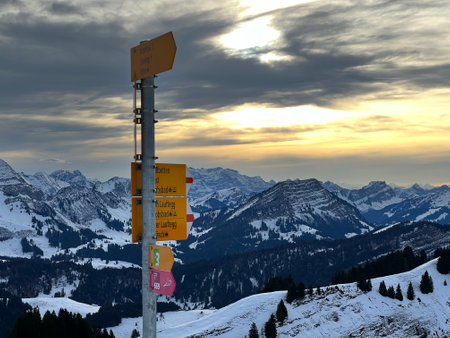 Hiking markings and orientation signs with signposts for navigating in the idyllic winter ambience on the Alpstein mountain massif and in the Swiss Alps, UrnÃ¤sch - Switzerlandの写真素材