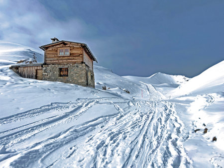 Old traditional swiss rural architecture and alpine livestock farms in the winter ambience of the alpine Swiss tourist resort Arosa - Canton of Grisons, Switzerland (Schweiz)の写真素材