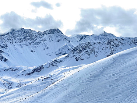 Beautiful sunlit and snow-capped alpine peaks above the Swiss tourist sports-recreational winter resort of Arosa - Canton of Grisons, Switzerland (Schweiz)の写真素材