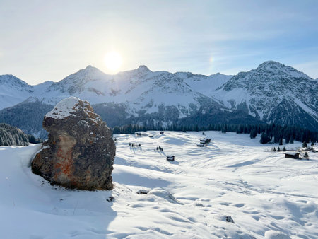 An early frosty morning and the rising sun over the snowy alpine peaks of the famous Swiss winter resort of Arosa - Canton of Grisons, Switzerland (Schweiz)の写真素材