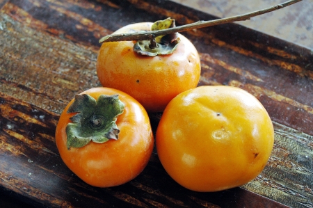 A persimmon with the branch which was able to be taken in the yard of the houseの写真素材