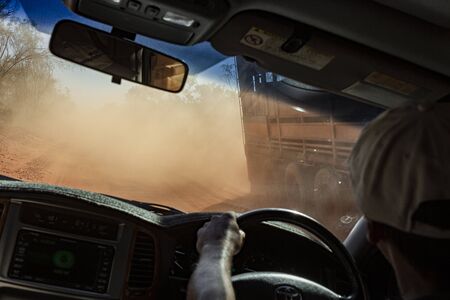 driving in the Australian outback on a dusty road