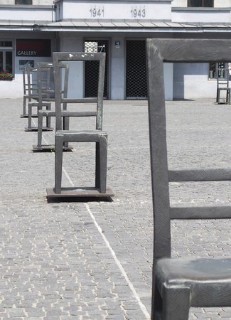 Krakow, Poland-June 11,2015:
square in Podgorze in Kracow with a ghetto memorial with empty ,iron chairsのeditorial素材